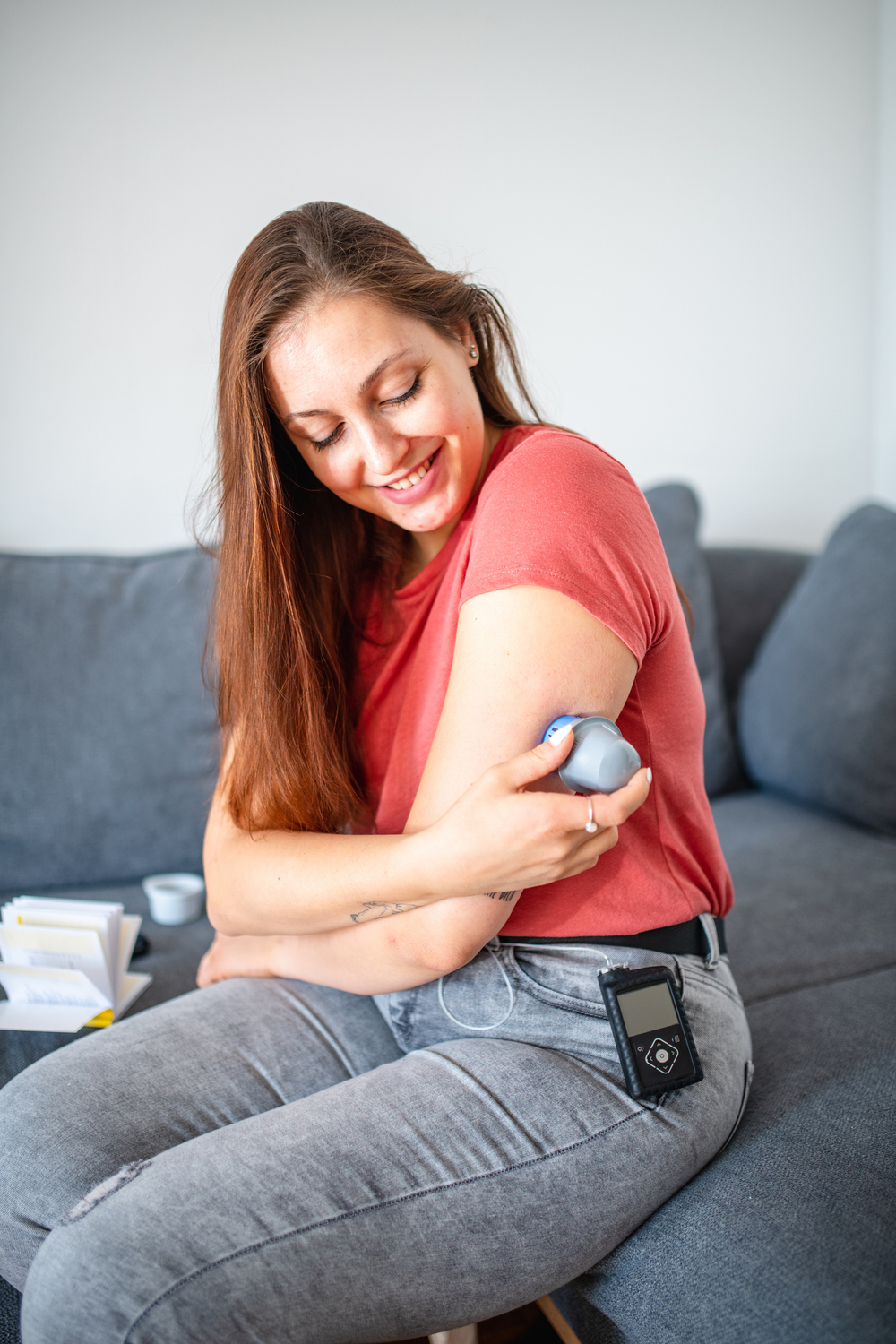 Young Woman with Type 1 Diabetes Applying Sensor to Arm
